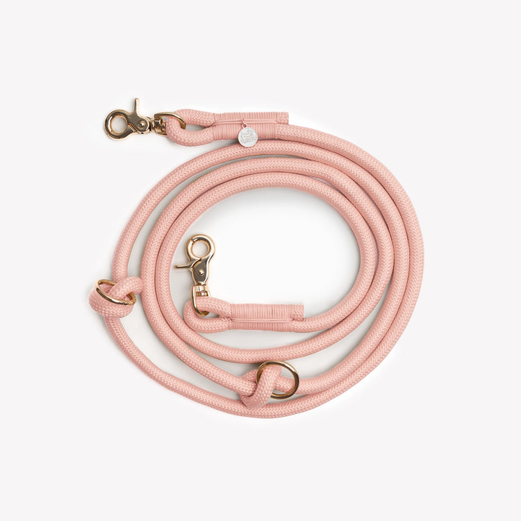 Light pink dog leash from Furlou with gold clasp on a white background
