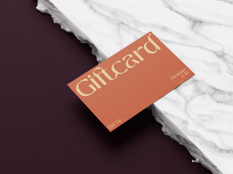 Gift card with 'Giftcard' text on a marble surface. Price 10CHF