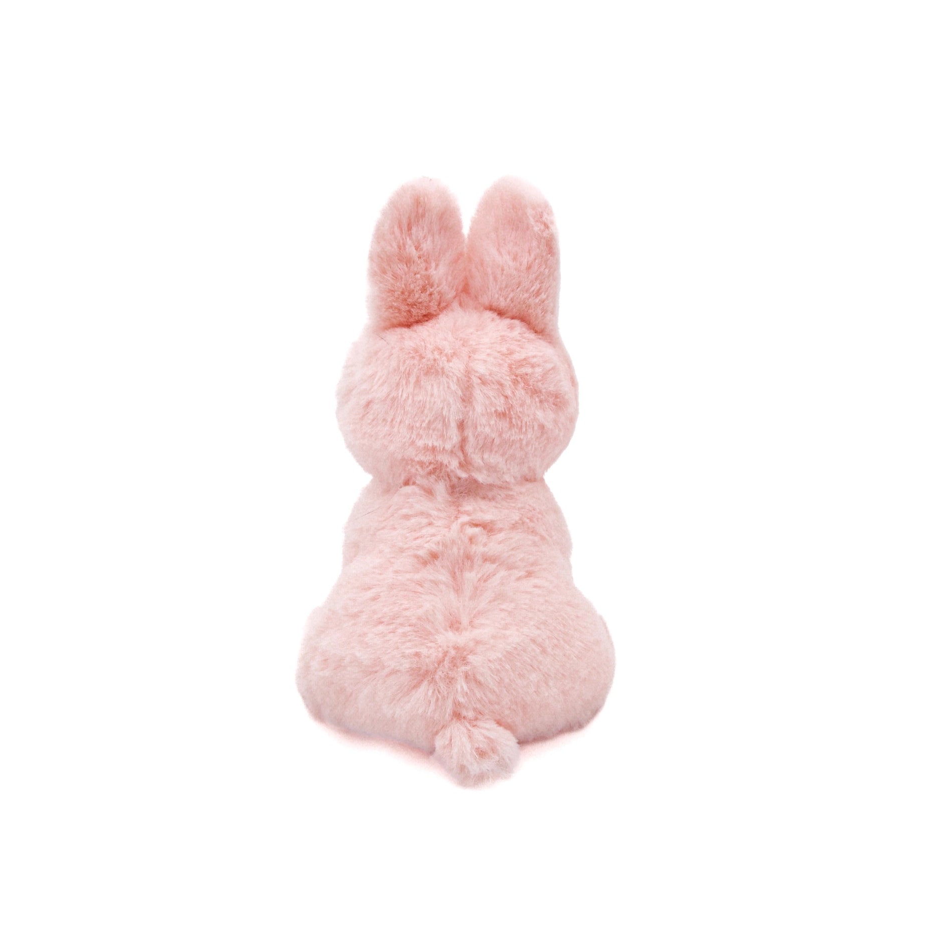 Pink plush bunny toy on a white background